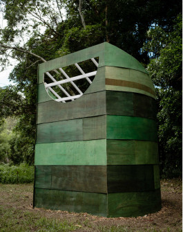 Curved green stained cladding on cylindrical architectural installation 